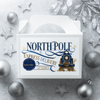 White North Pole Express treat box with navy and gold vintage train design, glitter accents, and elegant Christmas typography. Styled with silver baubles and frosted foliage on a wintry background.