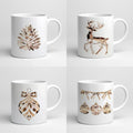 Four white mugs with gold Christmas-themed designs on a light gray background