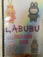 Labubu Colouring Book with pastel rainbow background and four cute bunny-monster characters on the front cover, featuring comb binding and colourful illustrated designs