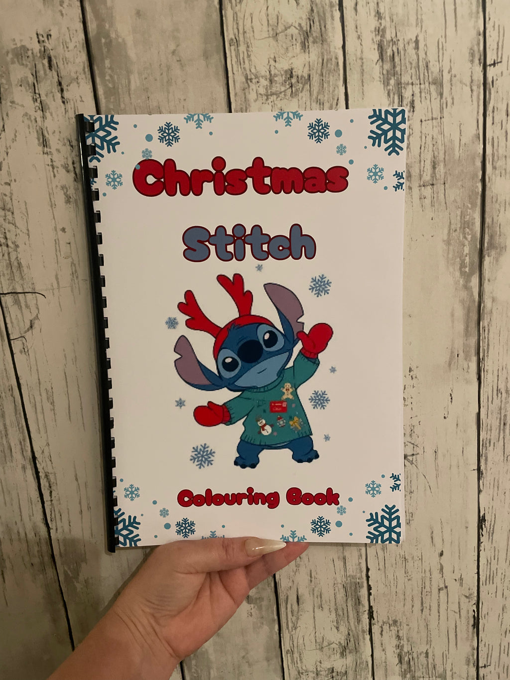 Blue Alien Christmas Colouring Book featuring cute holiday illustrations of a small blue space creature on a festive themed cover